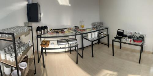 a room with two tables with food on them at Urupês Hotel in Urupês