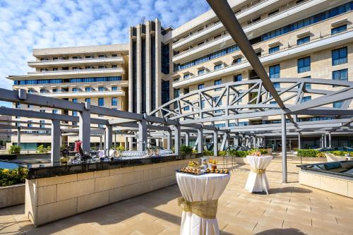 a large white building with a table in front of it at Hotel Nelva in Murcia