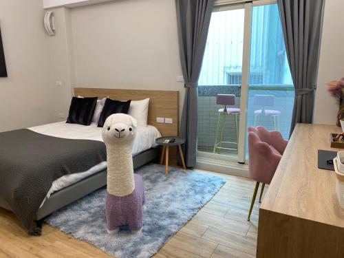 a bedroom with a bed with a stuffed animal at 漫光時旅民宿-電子入住 in Taitung City