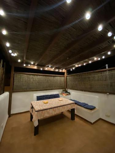 a room with a table and a couch and lights at Casa Mellis Aguamarga in Agua Amarga