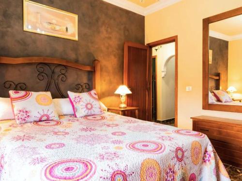 a bedroom with a large bed and a mirror at Live la Victoria Carril in La Victoria de Acentejo