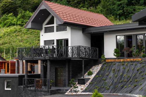 a house with a black and white at Villa in the Vineyard with Pool, HotTub & Sauna in Lendava