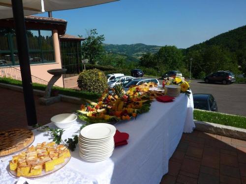 a table with plates and food on it at Villa Clorè Hotel & Spa in Lama Mocogno