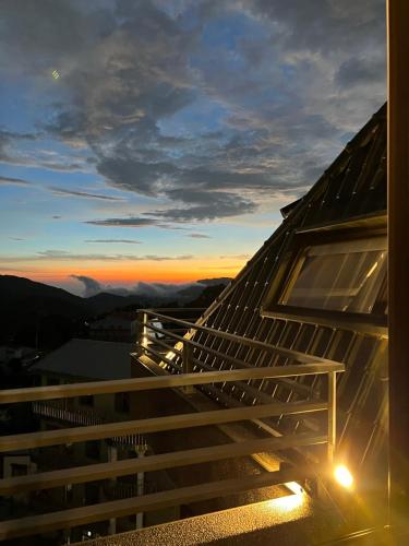a view of the sunset from the balcony of a house at Gaodiyuan Tea B&B 高帝園茶業民宿 in Meishan