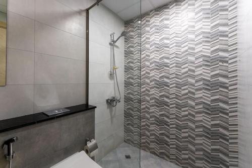 a bathroom with a shower with a glass door at Vibrant 2 Bedroom - E&G Homes in Dubai