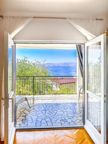 an open door to a balcony with a view of the ocean at Zimmer - Room - Magdalena in Senj