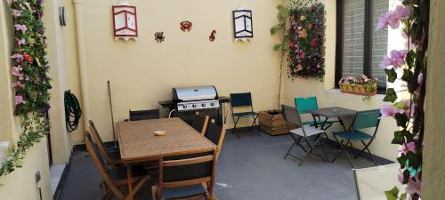 une terrasse avec une table, une cuisinière et des chaises dans l'établissement Cœur de Sète Le Patio 1, à Sète
