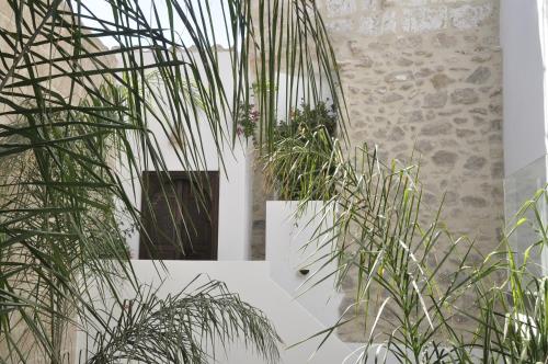 a room with potted plants and a stone wall at Ca Sana Teulada Moraira, Grupo Terra de Mar, alojamientos con encanto in Moraira