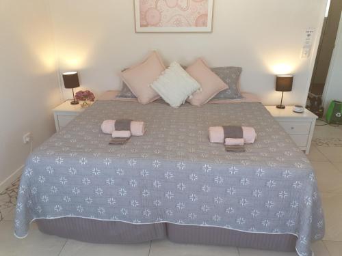 a bedroom with a bed with two towels on it at GUESTHOUSE on REGENT Bed & Breakfast in Caloundra
