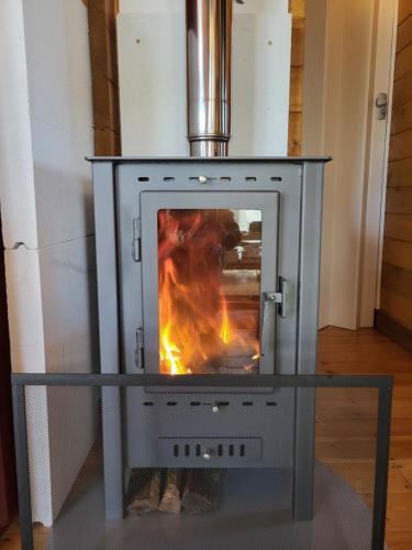 a stove with a fire inside of it at Chalet de Notre Dame in Le Tampon