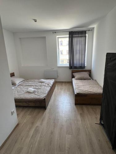 a room with two beds and a window at Dream Home in Szentes