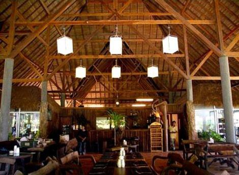 a large room with tables and chairs in a restaurant at The Narima - SHA Plus in Ko Lanta