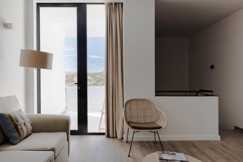 a living room with a couch and a chair at Memmo Baleeira - Design Hotels in Sagres