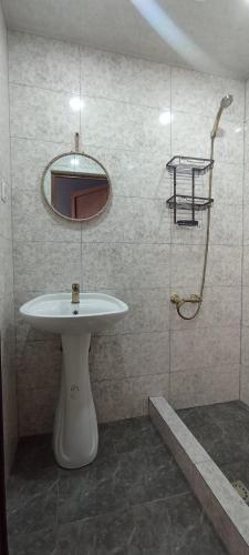 a bathroom with a sink and a mirror at Hooni_guesthouse in Odzun