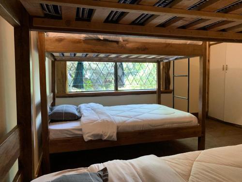two bunk beds in a room with a window at Mad Vervet Nairobi Backpackers Hostel in Nairobi