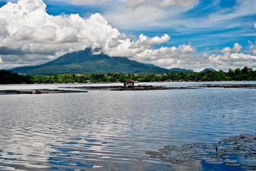 a large body of water with a mountain in the background at Kelys Transient San Pablo Laguna in San Pablo