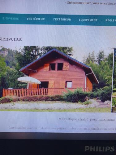 a website of a red house with an umbrella at Catarmina in Saint-Pancrace