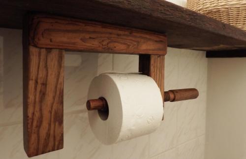 a roll of toilet paper hanging on a wall at Ferienhof Rauchhaus in Karft