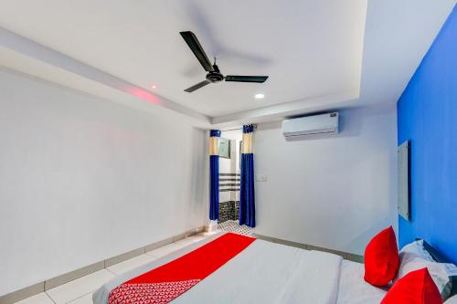 a room with a bed and a ceiling fan at SPOT ON Hotel Utrishree in Bhubaneshwar