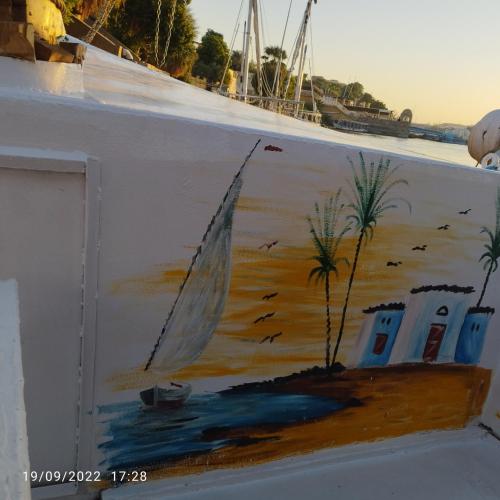 a painting of a sail boat on a wall at elizbeth in Nag` el-Ramla