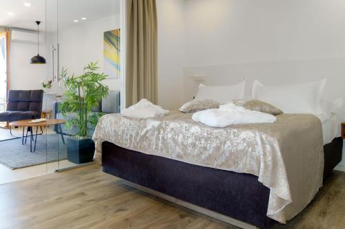 a bedroom with a large bed and a living room at Apartments Bikin in Brela