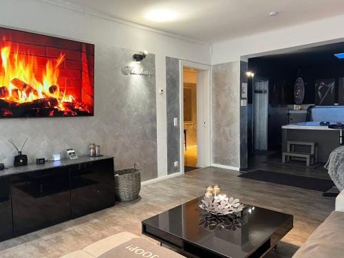 a living room with a fireplace in the wall at Platin City Apartment in Hamburg