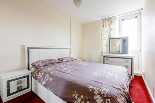 a bedroom with a bed and two night stands at One Bed (Entire Flat) - 25 mins from London Bridge in London