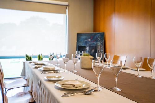 a long table with wine glasses and napkins on it at Posadas De España Paterna in Paterna