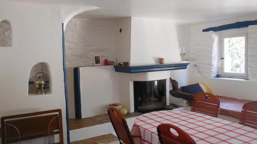 a living room with a bed and a fireplace at La bergerie in La Garde-Freinet
