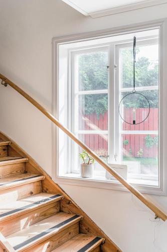 a staircase with a window and a chandelier at STUBBET - Charming - Newly Remade Villa in Vadstena
