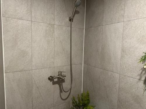 a shower with a shower head on a wall at 8 Hotel in Seoul