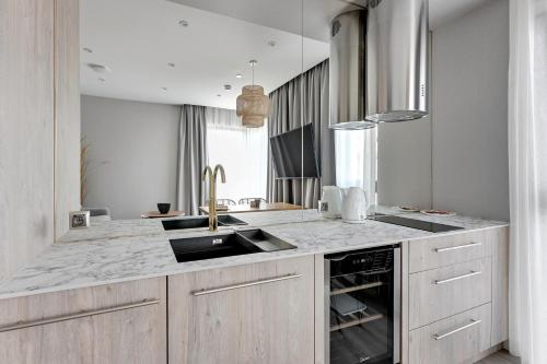a kitchen with a sink and a counter at GRANO HOTEL Solmarina in Wiślinka