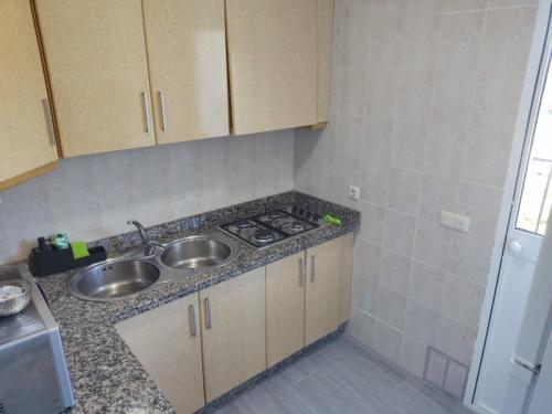 a small kitchen with a sink and a stove at casa Encarni, balcon de las cuevas in Setenil