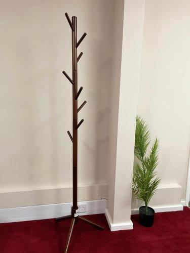 a metal cross in a room with a plant at Stylish Home Away From Home in Kent with Easy Access to London! in Wrotham