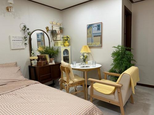 a bedroom with a bed and a table and chairs at 8 Hotel in Seoul