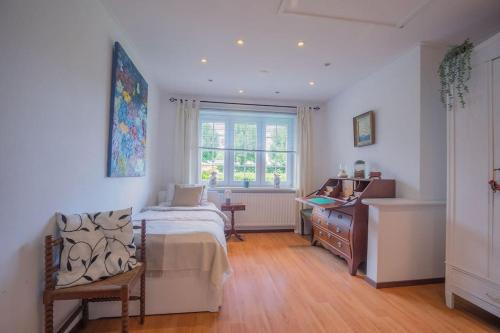 a bedroom with a bed and a dresser and a window at Countryside - Experience in Koewacht