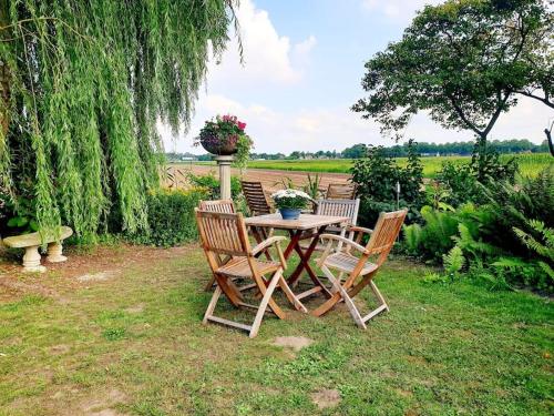 a table with two chairs and a table with flowers on it at Countryside - Experience in Koewacht