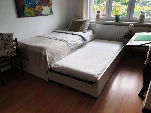 a bed sitting in a room with a window at Countryside - Experience in Koewacht