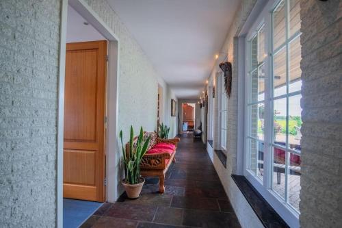 a hallway of a house with a couch and windows at Countryside - Experience in Koewacht