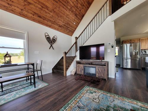 a living room with a fireplace and a tv at Hunters Haven in Luray