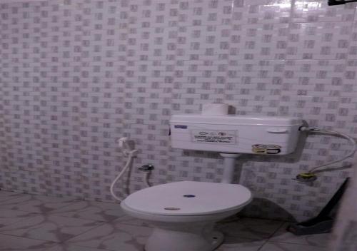 a bathroom with a white toilet in a room at Camp David, Kigwema in Kohīma