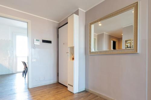 a hallway with a mirror and a door at Milan Retreats in Milan