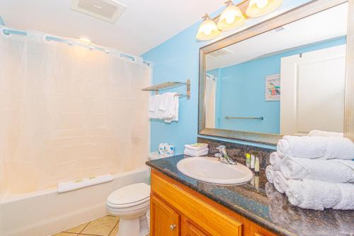 a bathroom with a sink and a toilet and a mirror at 1 Bedroom Suite with City and Partial Ocean Views- Bay View Resort 702 in Myrtle Beach