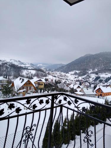a view of a town in the snow from a balcony at Apartamenty Na Brzegu Szczawnica in Szczawnica