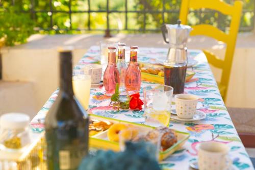 a table with bottles of wine and food on it at Casa Rural Casa Las Flores in Tíjola