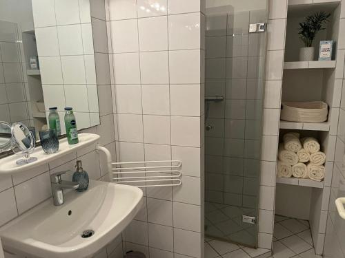 a bathroom with a sink and a shower with a mirror at Ostsee Traum 
