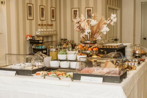 a buffet of food on a table in a room at Palazzo Bezzi Hotel in Ravenna