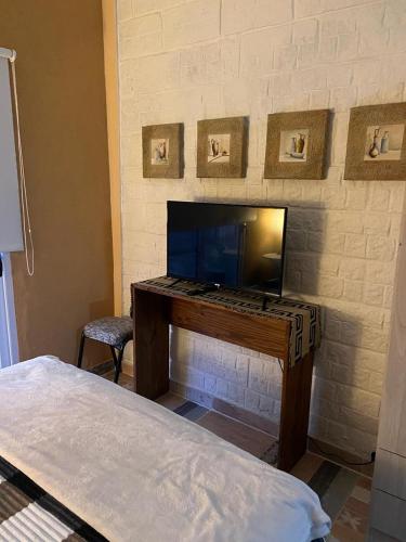 a desk in a room with a fireplace at Alquiler x dia in Libertador San Martín