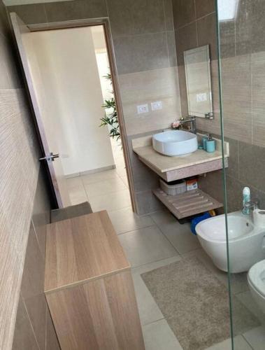 a bathroom with a toilet and a sink and a mirror at Luxury Apartment Dominicus in La Laguna