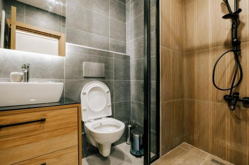 a bathroom with a toilet and a sink and a shower at Flat w Jacuzzi 2 min to Metro Near Marmara Park in Istanbul